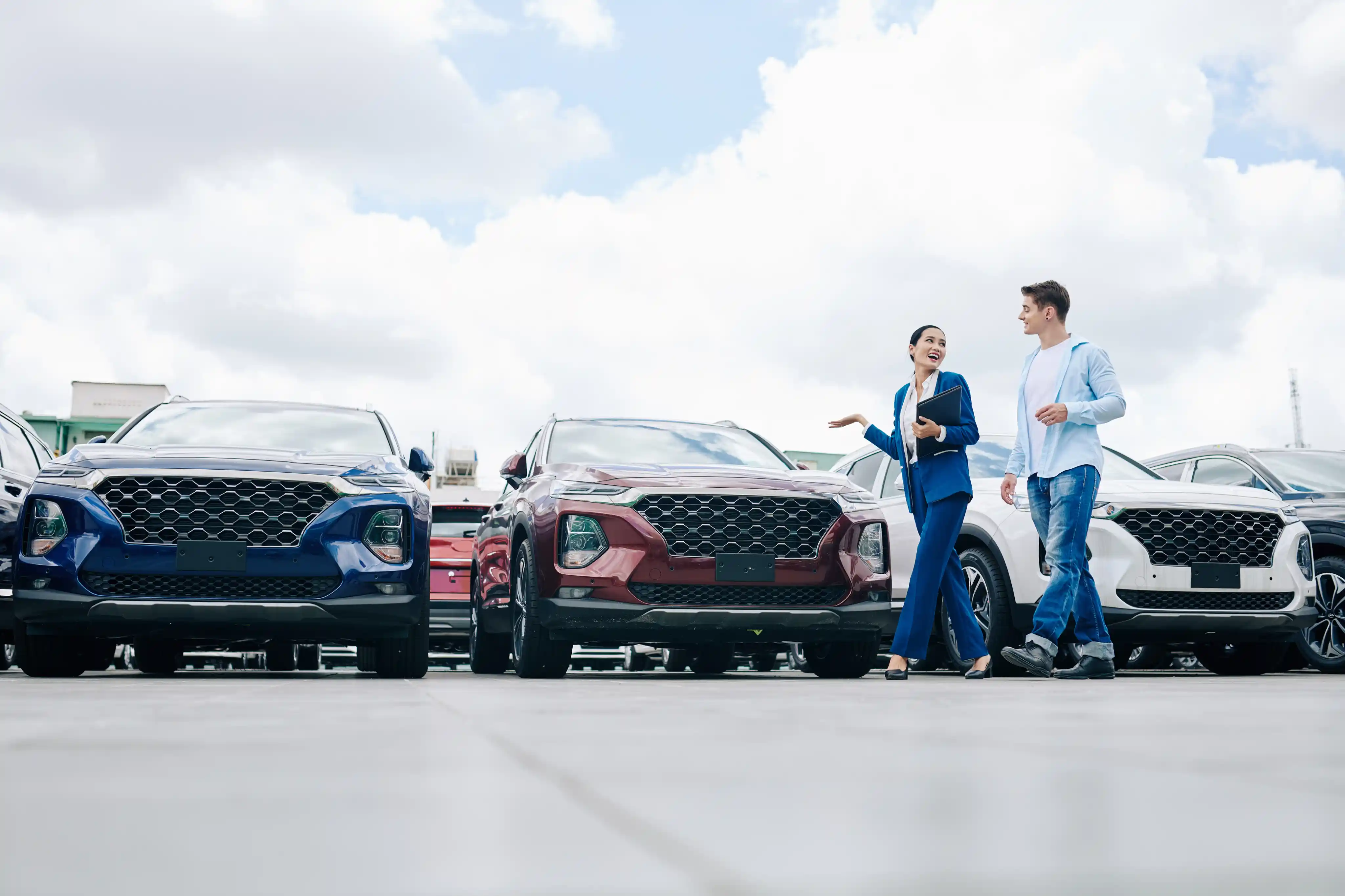 A car dealer walking outside with a customer