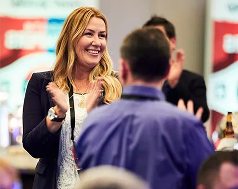 A closeup of employees smiling at a work event