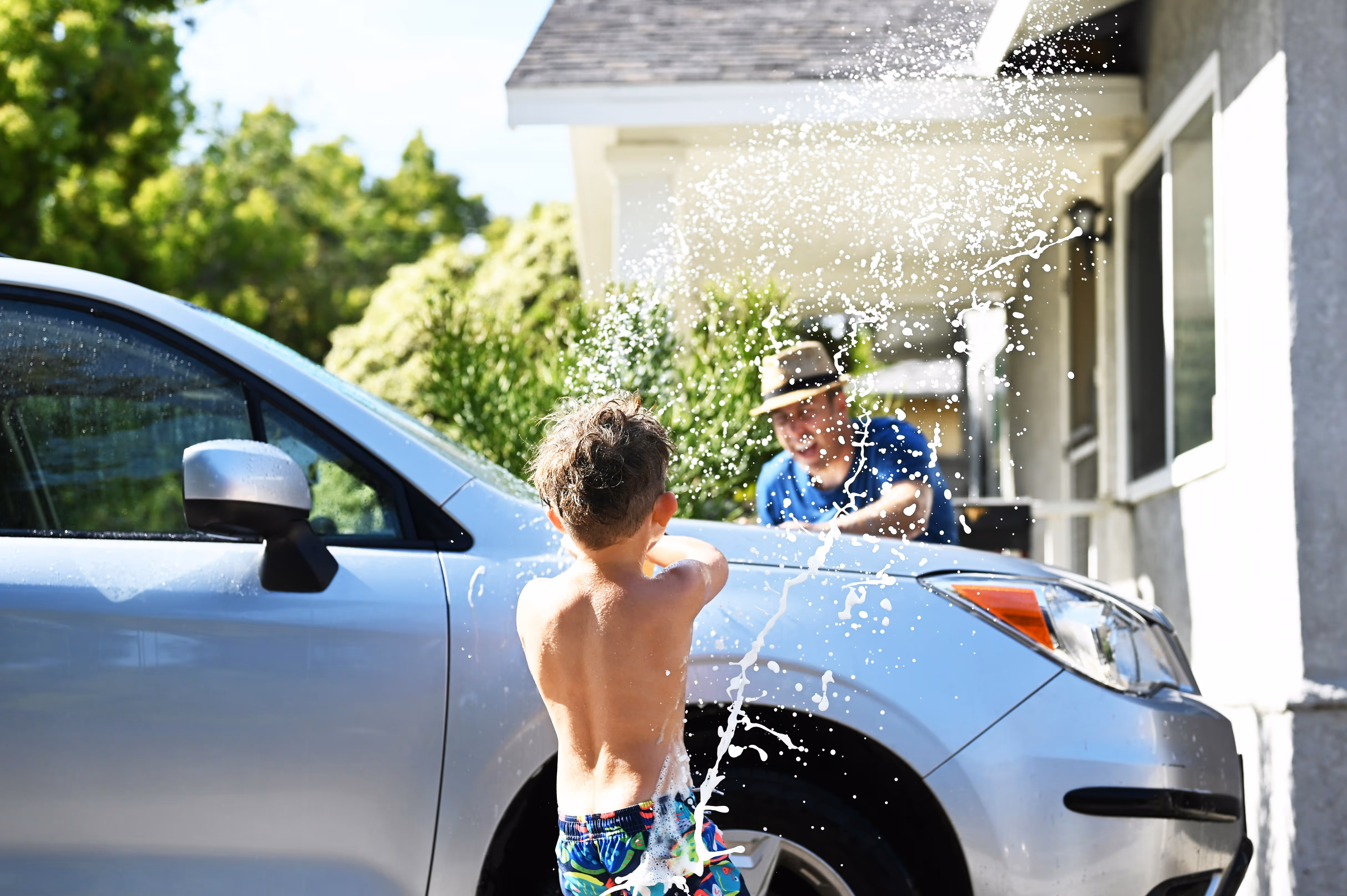 Father and son washing a car