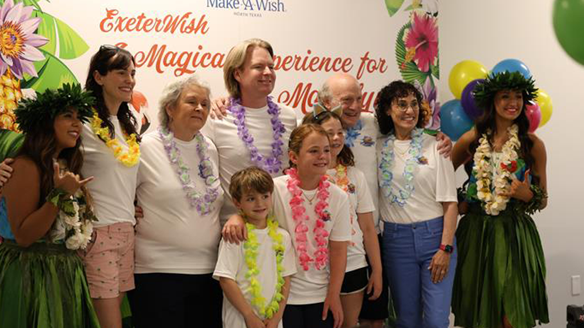 A young cancer-survivor and her family receiving a gift from Exeter Finance's leadership team.