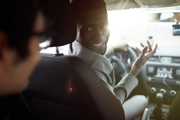 Two men talking inside of a car