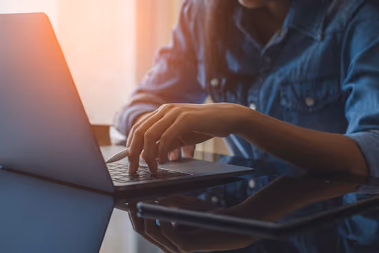 Closeup of someone typing on their laptop